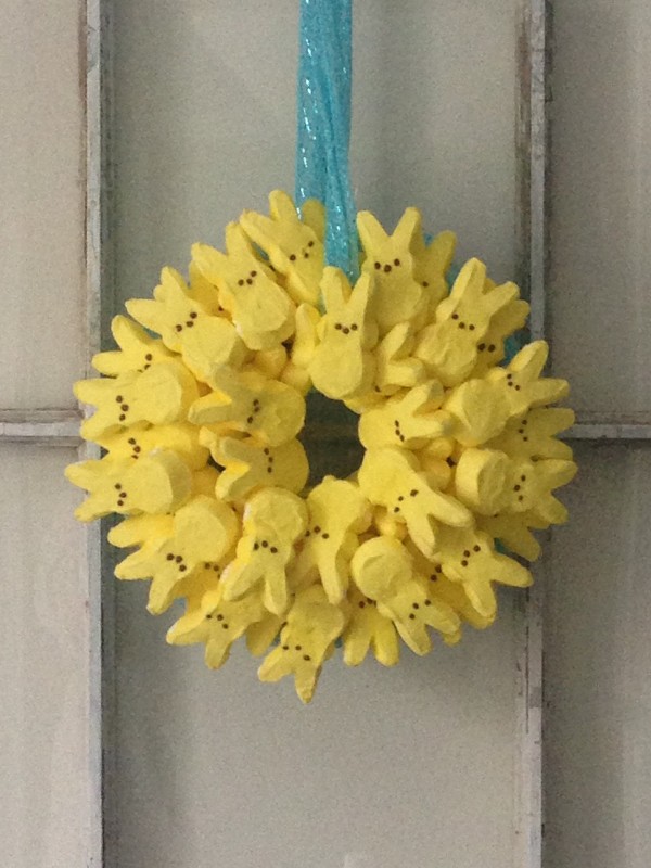 Yellow easter peeps formed in a circle to make a wreath.