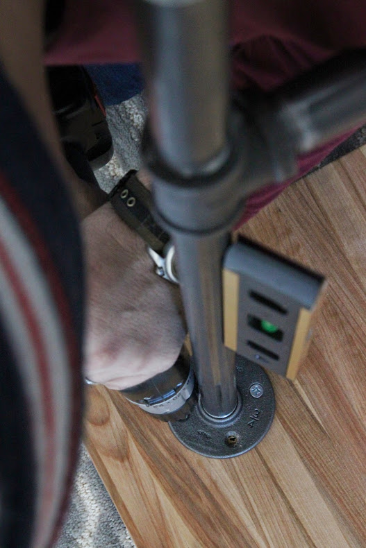 Screwing the legs into the butcher block, up close picture.