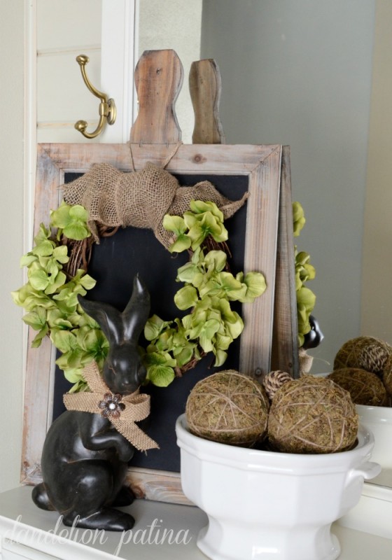 A rustic looking hydrangea wreath with a small kangaroo figurine in front of it.