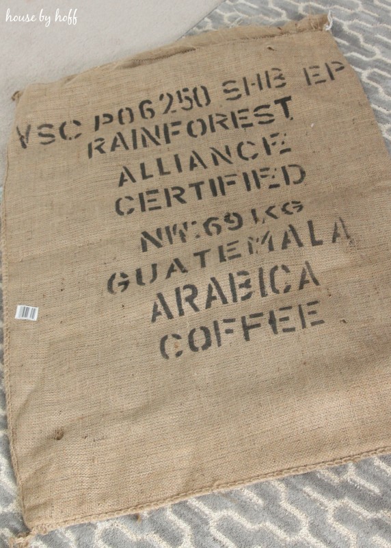 A burlap coffee bag on the carpet.