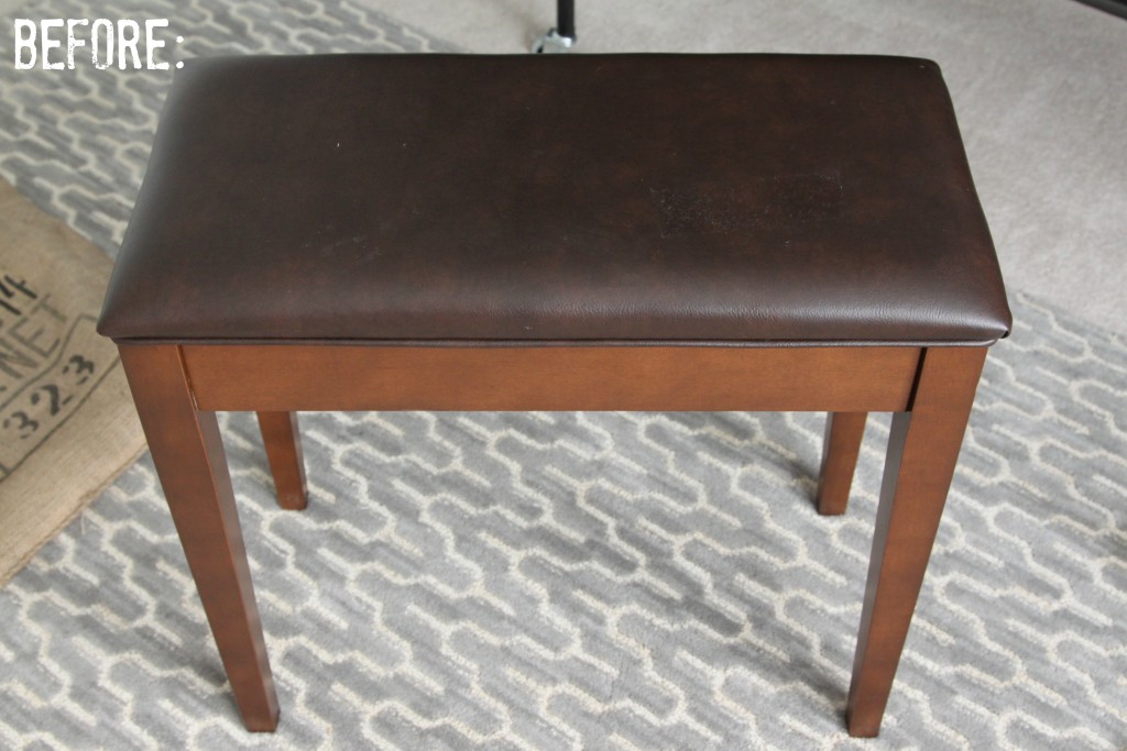 A brown leather and wooden piano bench seat.