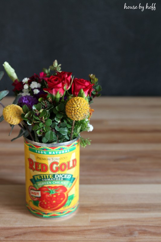 Vibrant floral bouquet in a tin can.