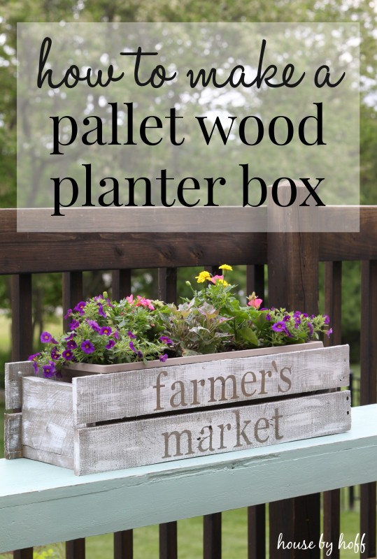 The pallet wood box on a ledge with flowers in it.