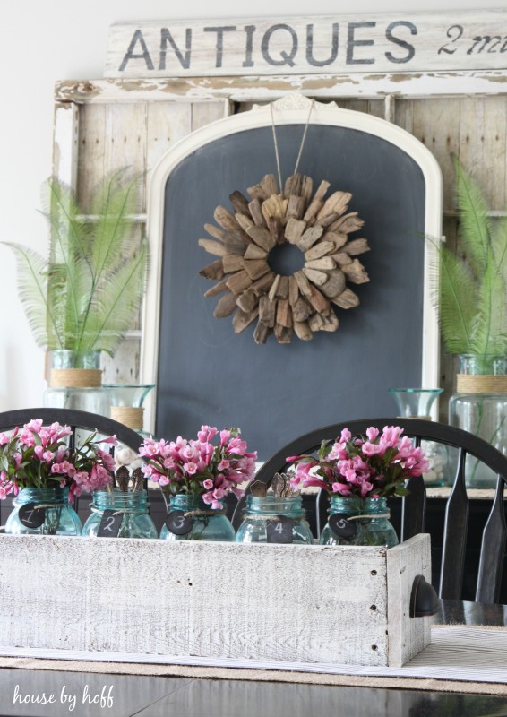 Large antique sign behind dining room table.