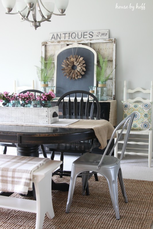 Dining table with pink flowers on it.