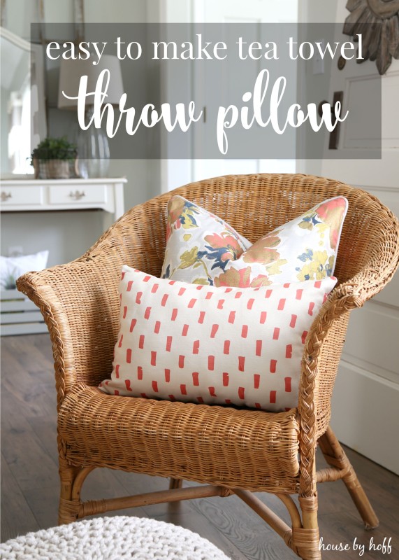 Wicker chair with 2 throw pillows on it.