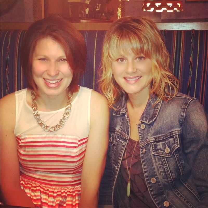 Two girls sitting in a restaurant.