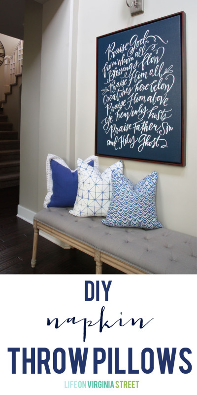 Blue and white pillows on a grey bench.