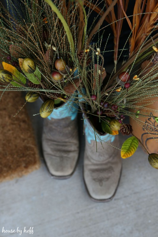 Aerial view of the wheat grass in the cowboy boots.