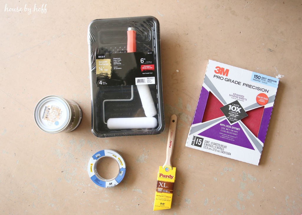 Paint brushes and tape sitting on counter.