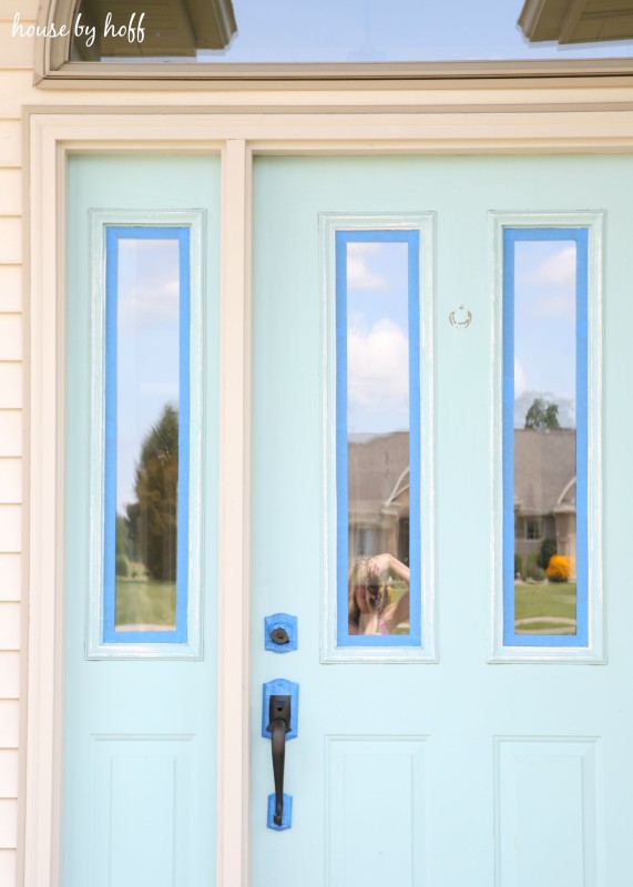 Taping the door around the windows and handle.