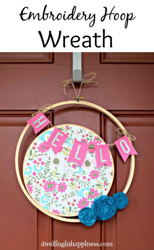 Hoop wreath with floral fabric hanging on a door.