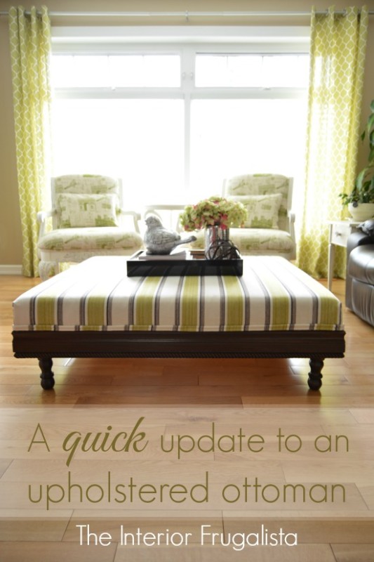 A green and white ottoman with dark wood legs.