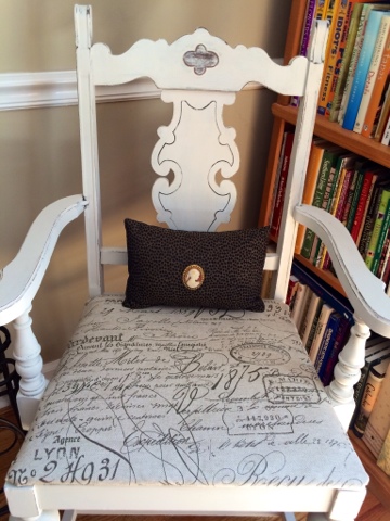 White chair with French vintage pillow cushion.