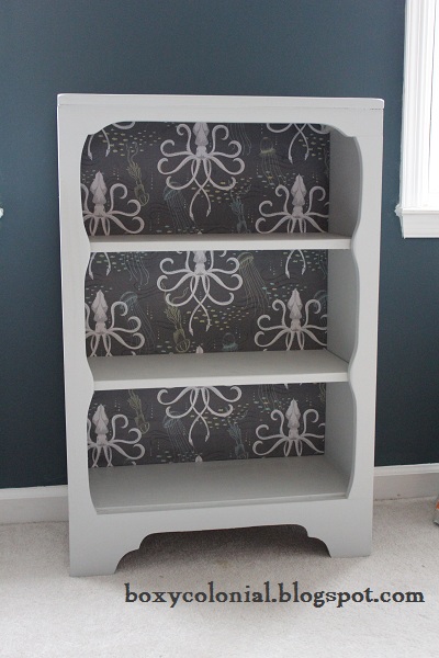 Bookshelf with black and white fabric on the backside.