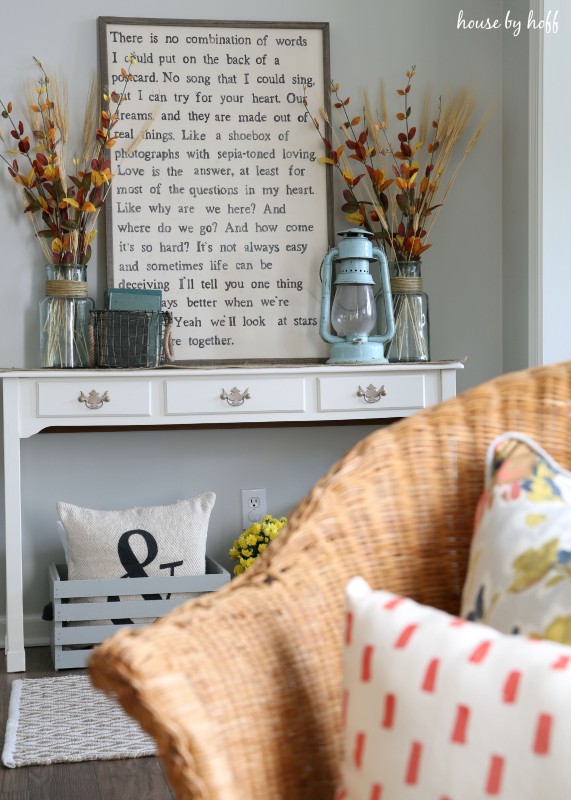 Wooden crate with pillow in it under the side table.