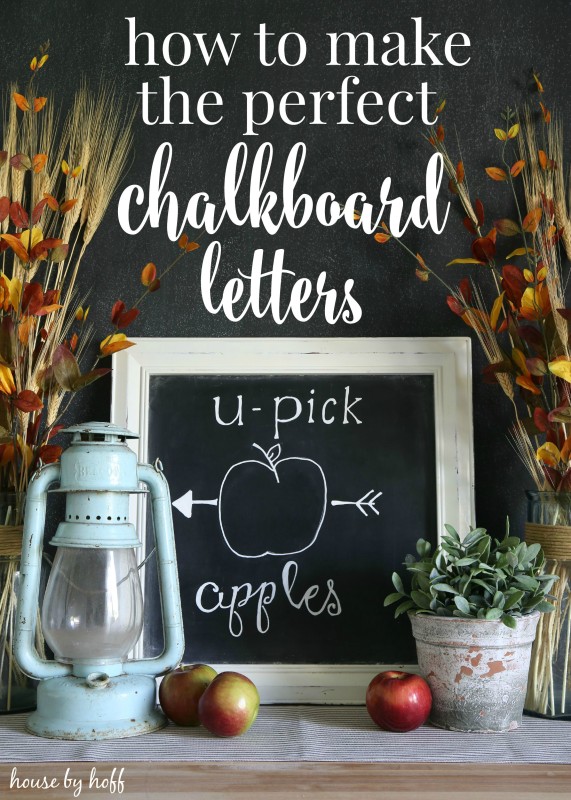 Chalkboard letters on a chalkboard with apples and plants around it.