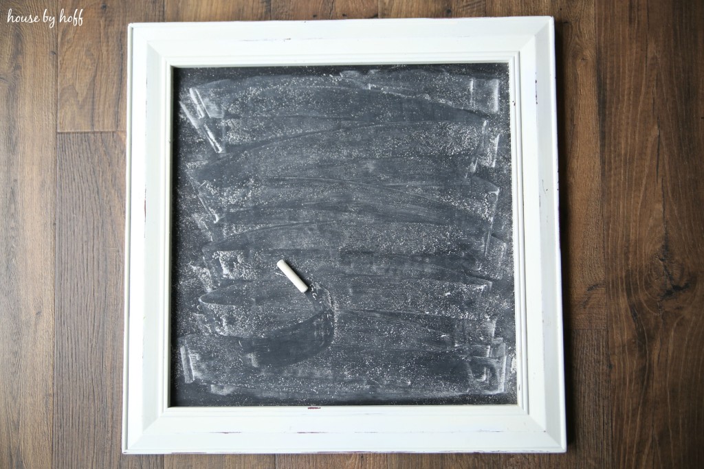 Black chalkboard with chalk sitting on it.