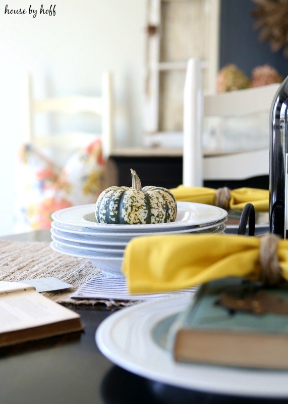 Pumpkins in a bowl on the fall table setting.