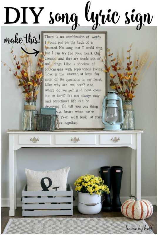 Fall vignette with side table, DIY song lyric sign, ruler boots beneath the table, a pumpkin and fall leaves in vases on table.