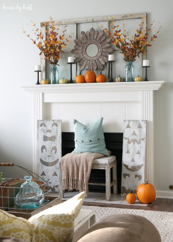 Beige rug in front of fireplace.