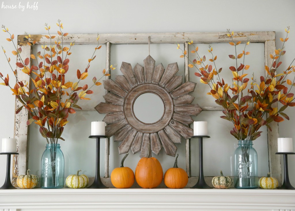 Wooden mirror hanging above mantel.