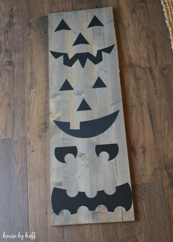 Putting the pumpkin faces on the wood.