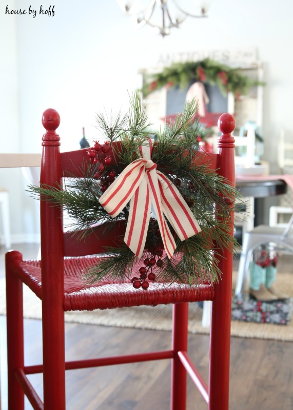 A striped red and white bow tied to the stool.