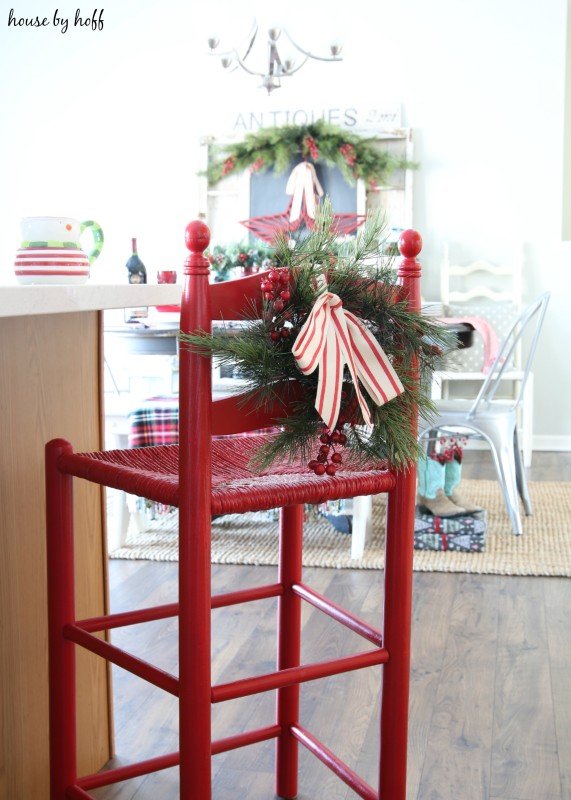 A red stool at the bar in the kitchen.