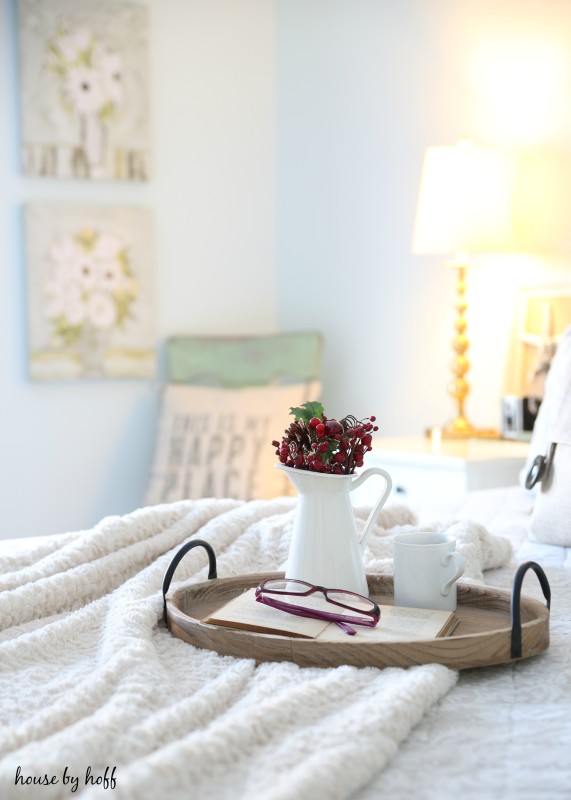 The tray on the bed and the lamp in background turned on.