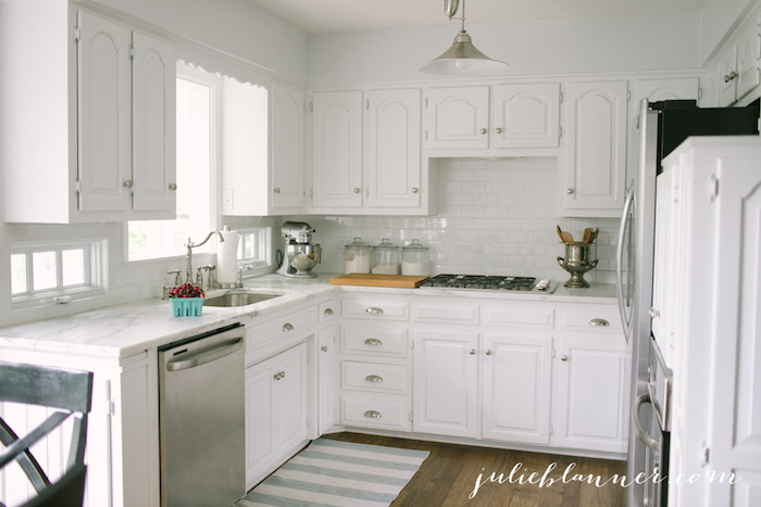 A traditional white kitchen with stainless steel appliances.