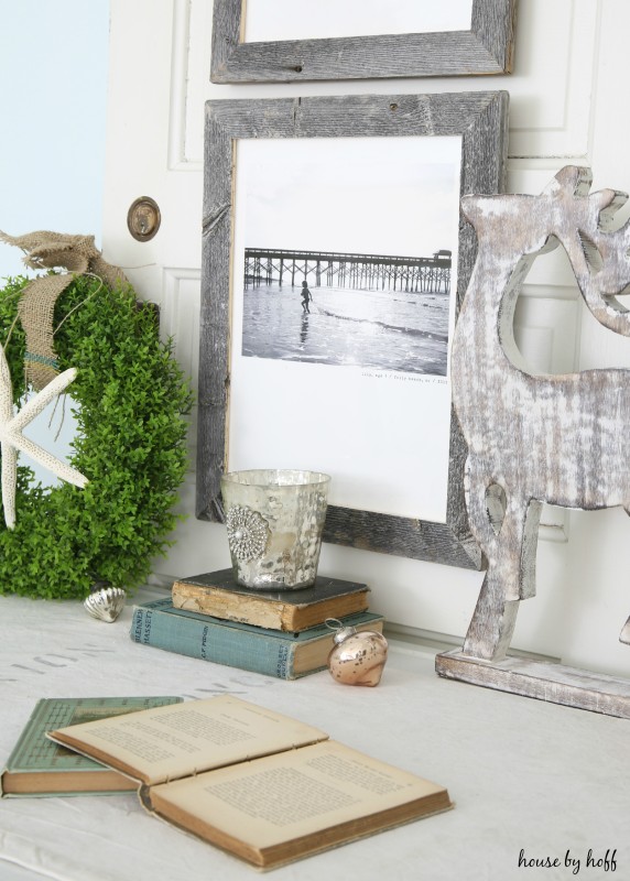 Christmas ornament on the desk with deer and antique book opened.