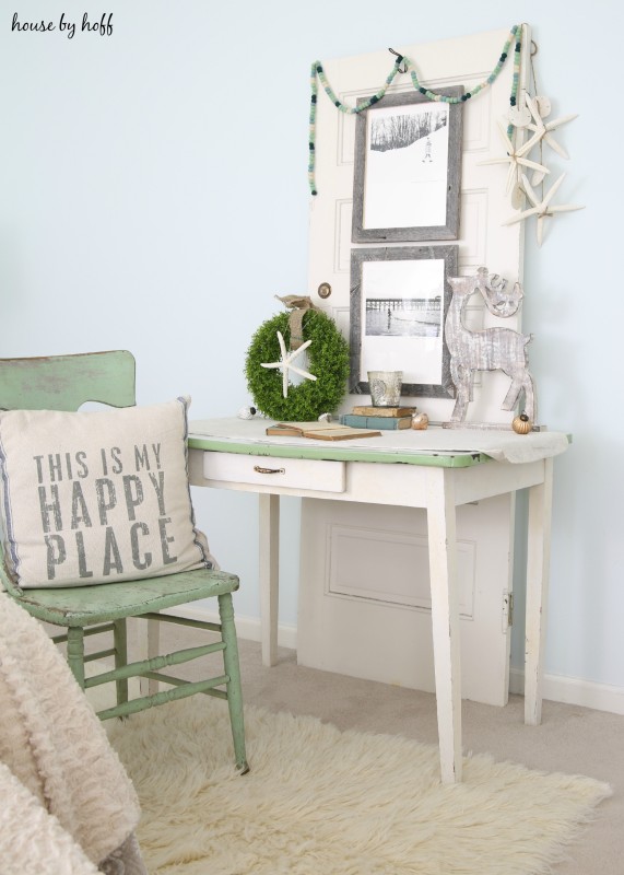 Light green wooden chair, wooden desk, and faux white fur.