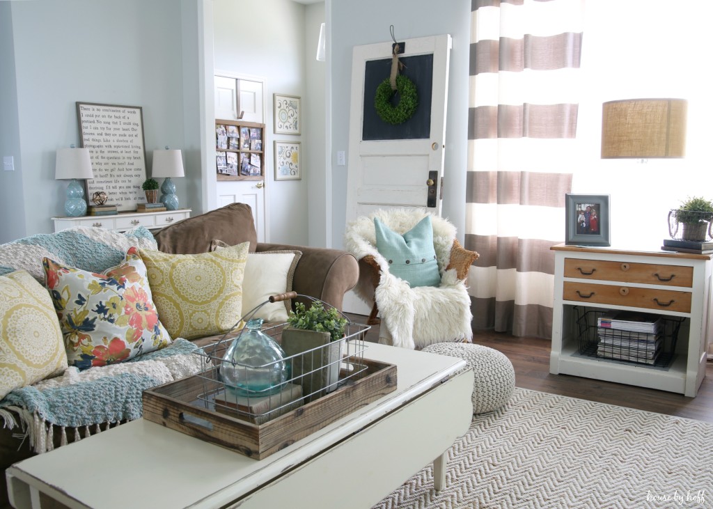 A white rustic living room table, couch, chair and small cabinet. 