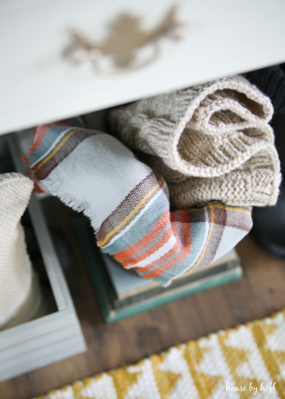 Plaid blankets underneath the table.