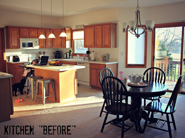 An older kitchen with wooden cabinets and dark brown table and chairs.