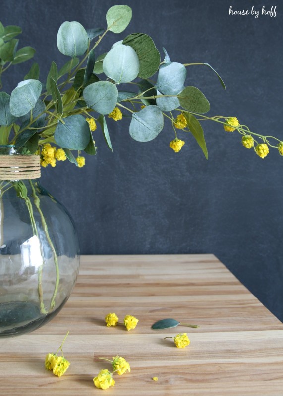 The centrepiece on the wooden table in front of a chalk wall.