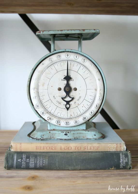 Vintage scale sitting on vintage books.