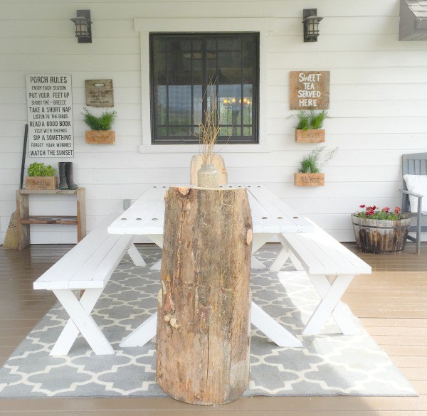 A white picnic table outside on the porch.