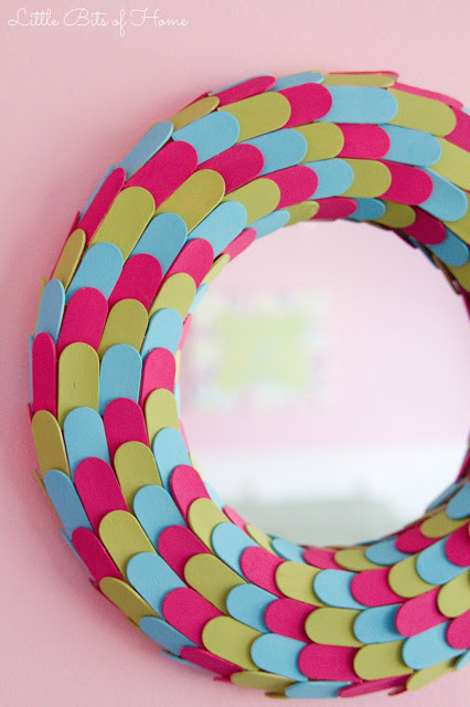 A brightly coloured popsicle stick mirror.