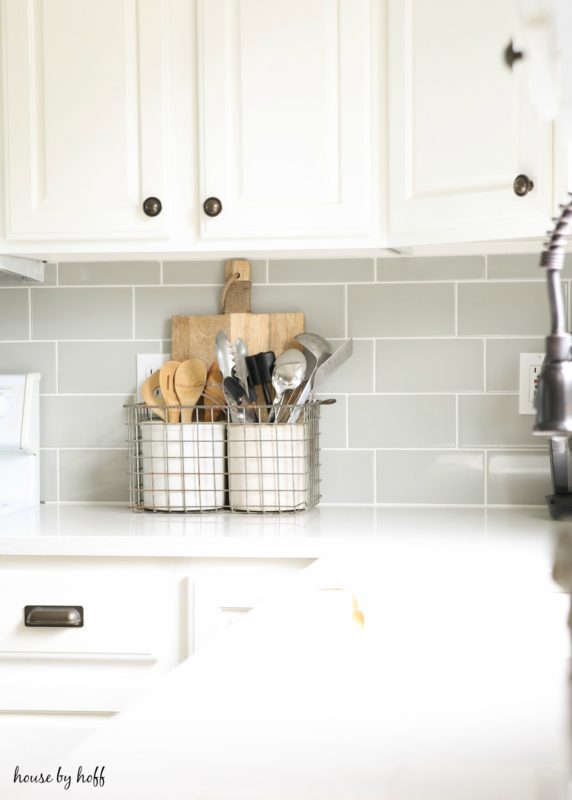 Utensils in wire baskets on counter.