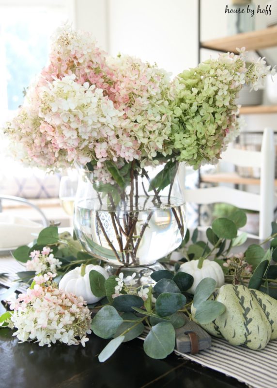 Hydrangeas and pumpkins on dining room table.