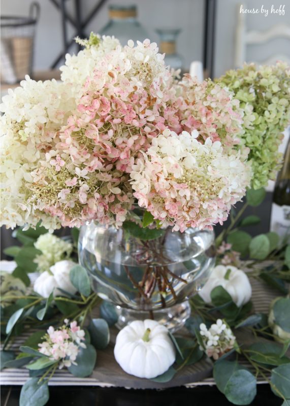 Pink hydrangeas with green hydrangeas in vase.