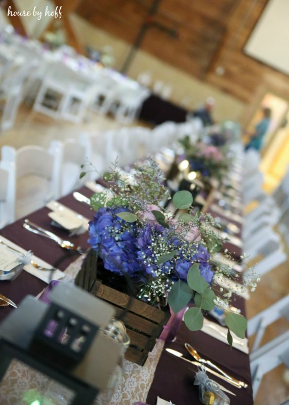 Decorated tables with purple flowers.