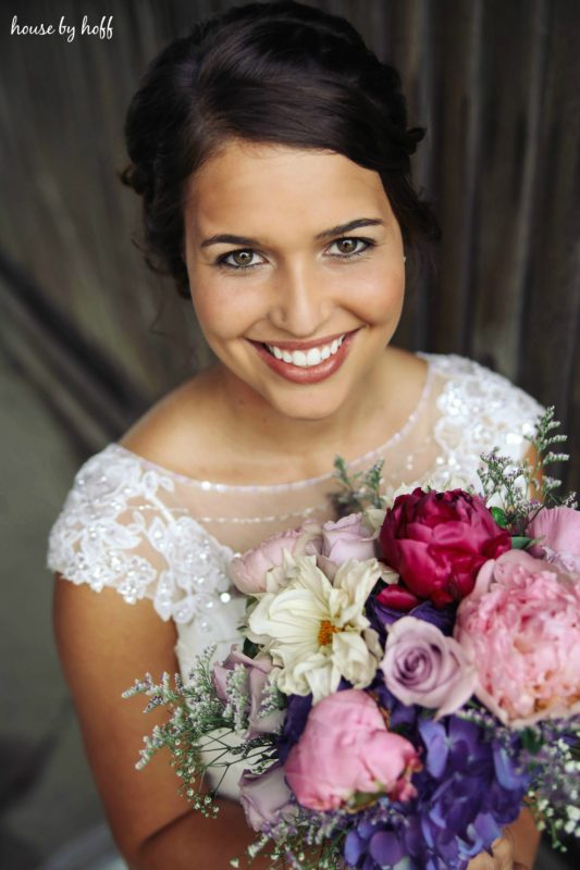 The bride with her bouquet smiling.