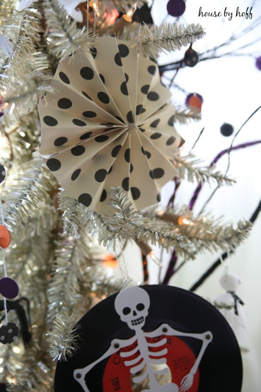 Black and white polka dot decorations on the white tree.