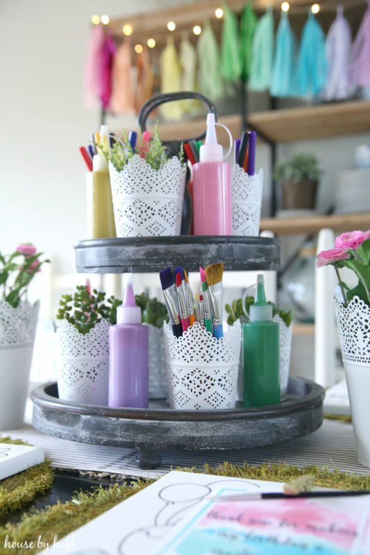 Paint brushes in a white containers.