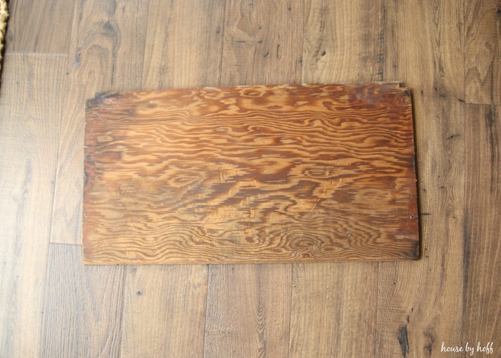 Old piece of wood on the floor to make the sign.