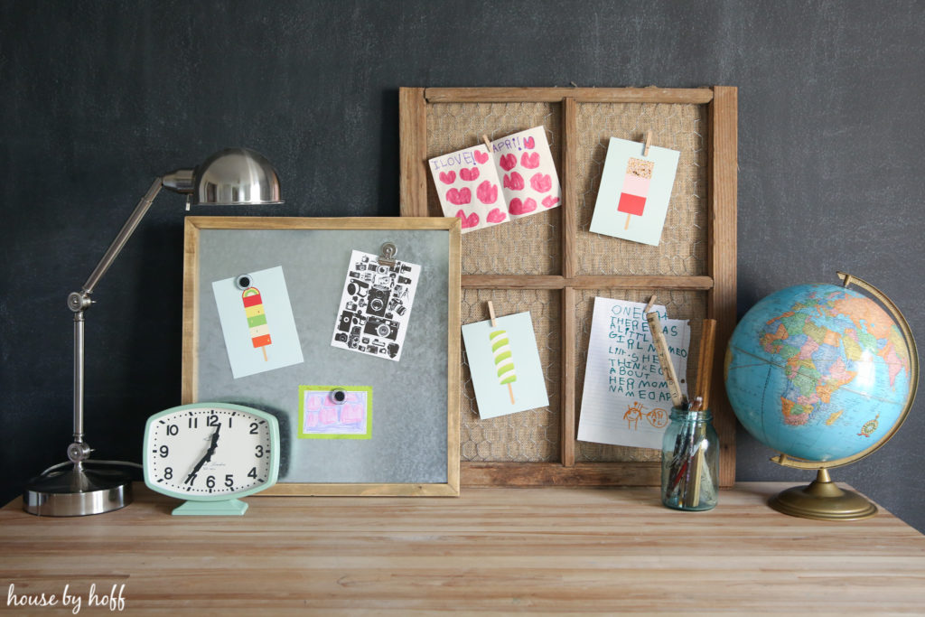 Desk filled with a lamp, and a board to put up pictures.