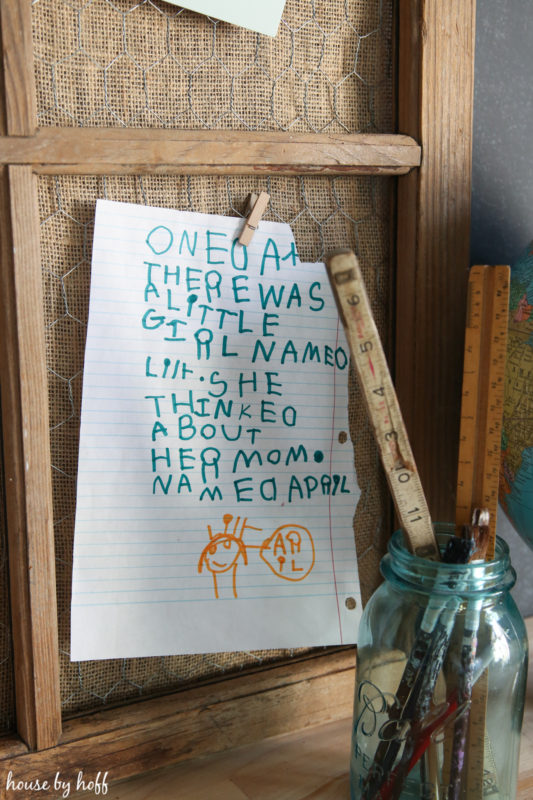 A poem written by a child hanging on the board by a clothes pin.